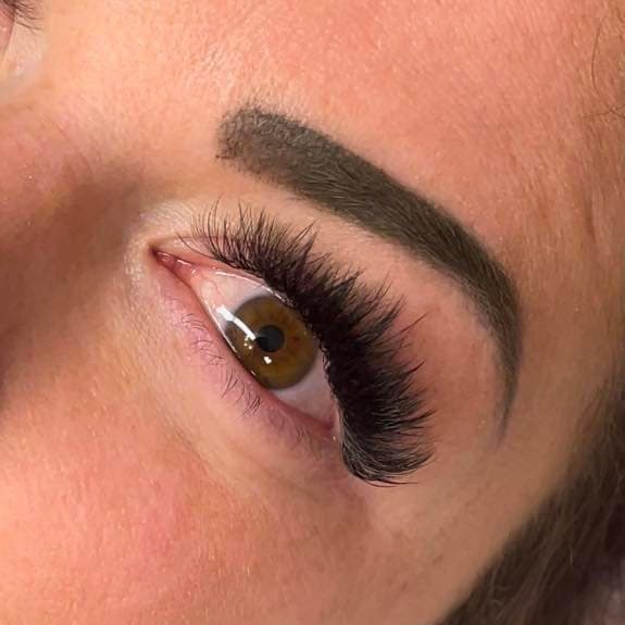 Close-up volume lash extensions — brown eye