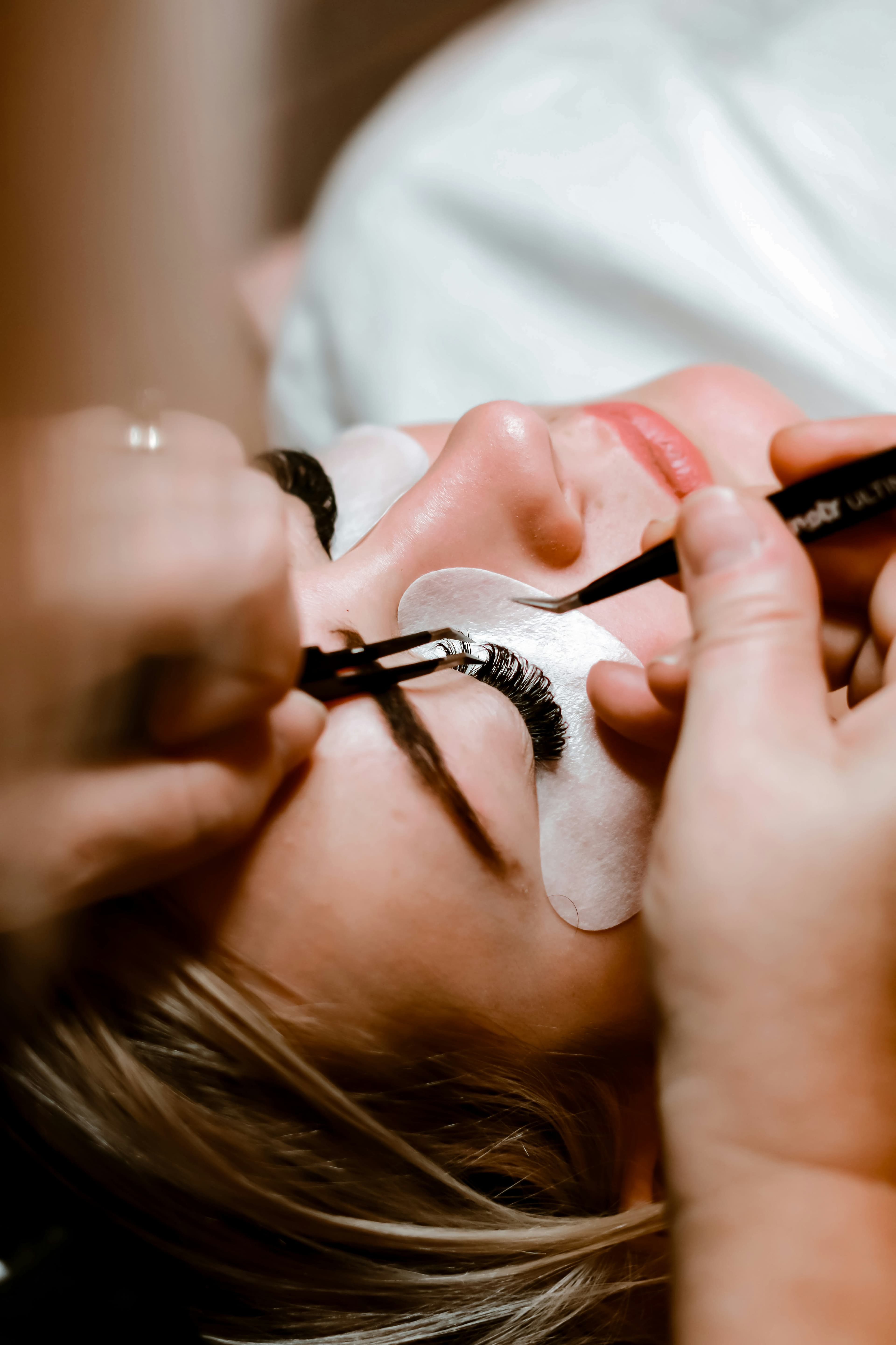 Lash artist performing a precision lash application