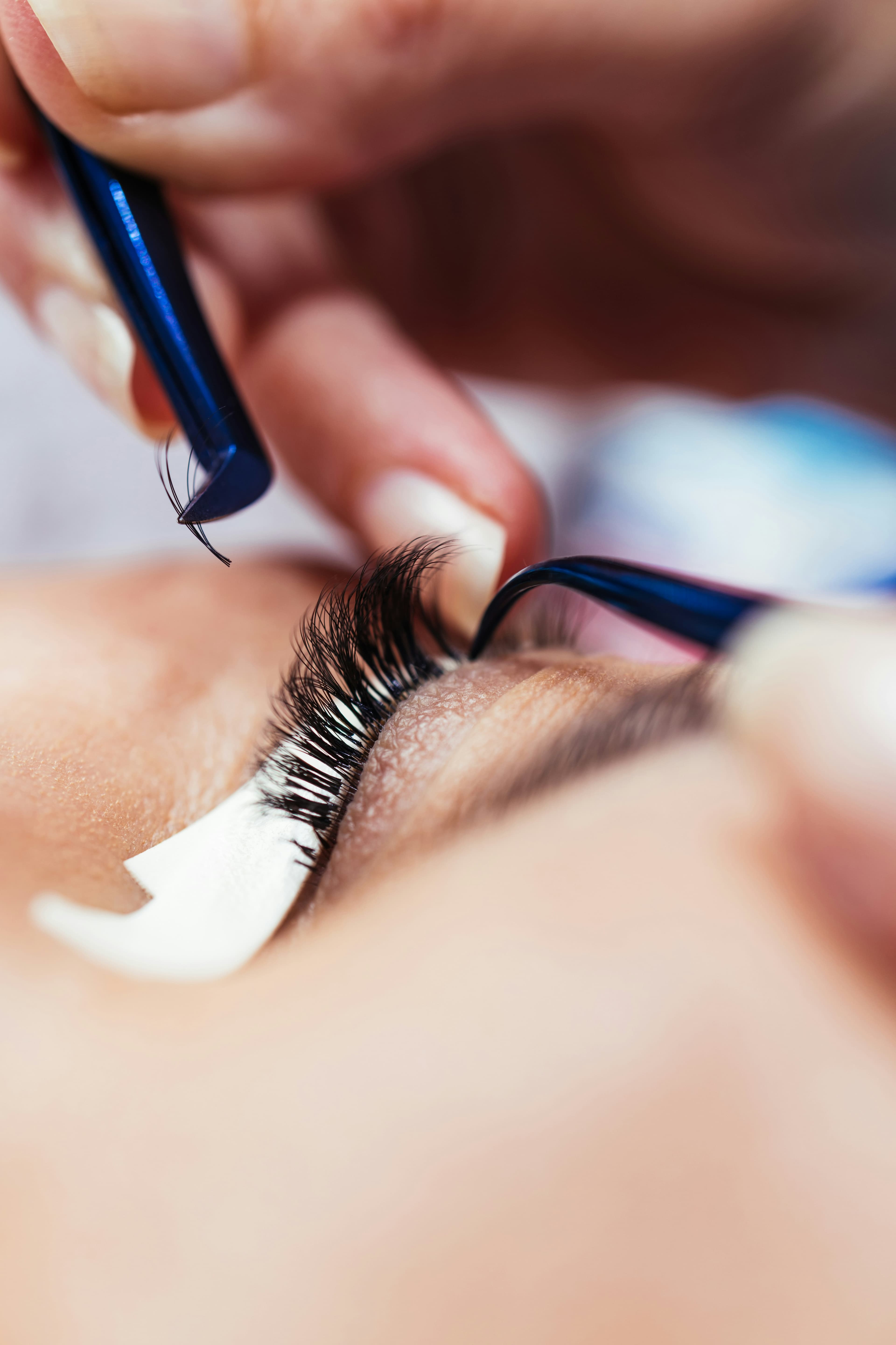 Macro close-up of lash extension application